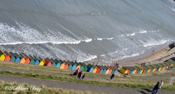 Day trip to Whitby England Colorful Beach Shacks pebblepirouette.com #whitby #england #ruins #beach 